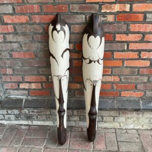 Pair of vintage African carved wooden masks with geometric designs.