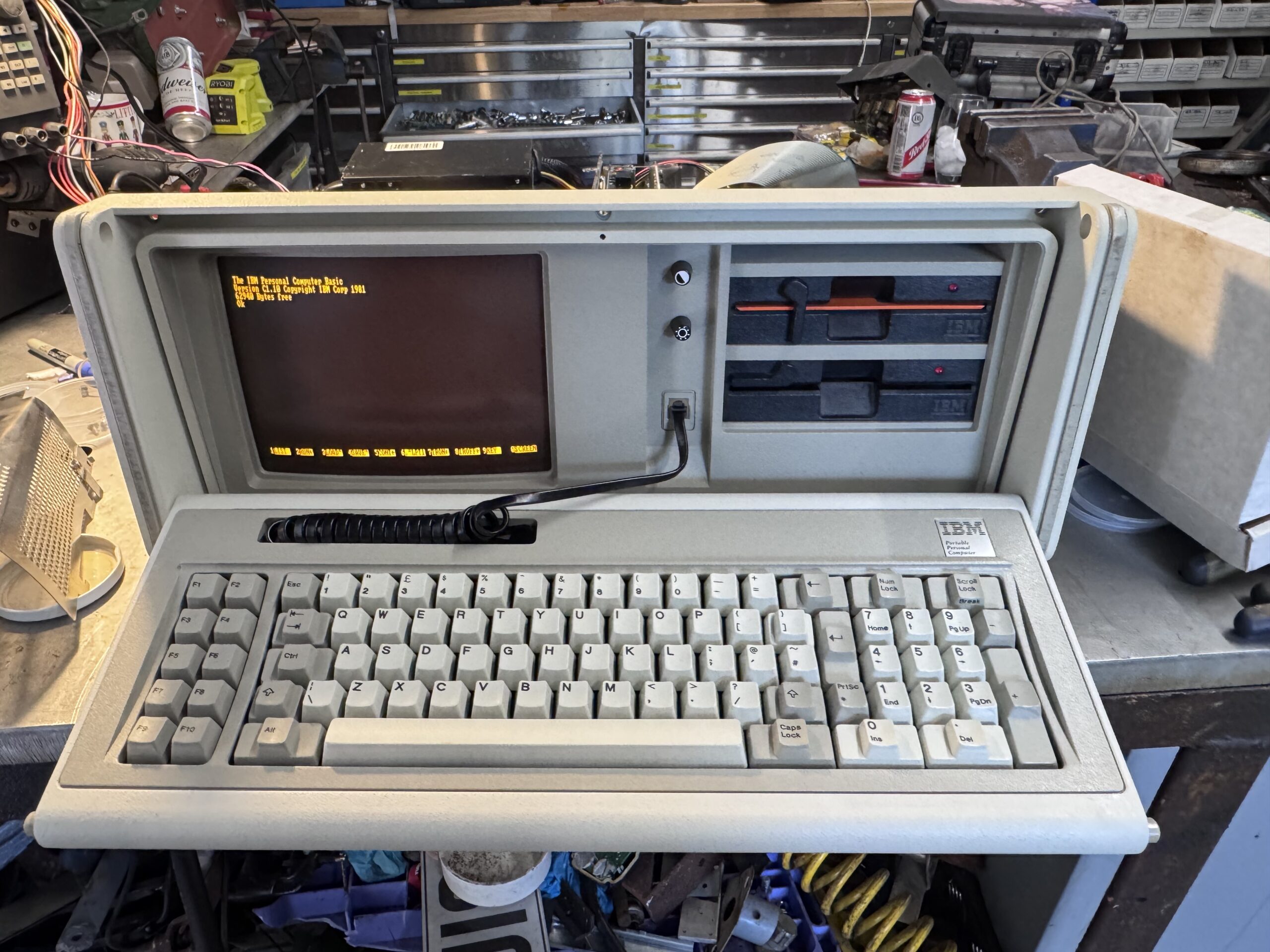 IBM logo on the vintage 5155 portable computer near the keyboard.