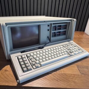IBM 5155 Overview Vintage IBM 5155 portable computer on a wooden table.