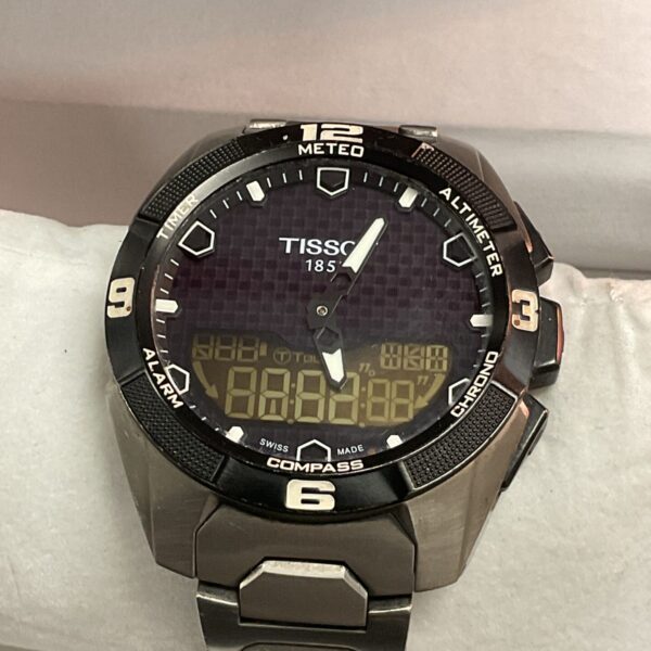 Close-up of a stainless steel Tissot digital chronograph watch.