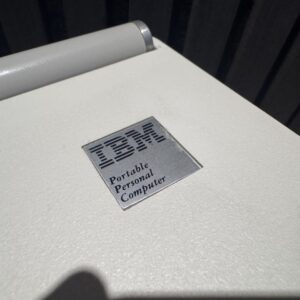 Vintage Laptop Side view of a vintage portable laptop computer.