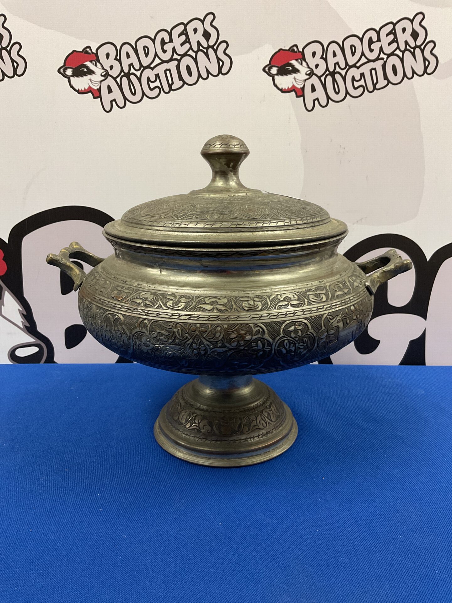 Large vintage silver plate pot with lid and detailed handles.